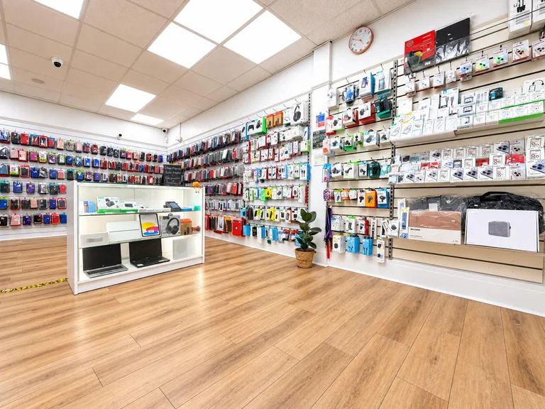 Interior of Phones & Repair Hub showing the accessory walls and product display counter